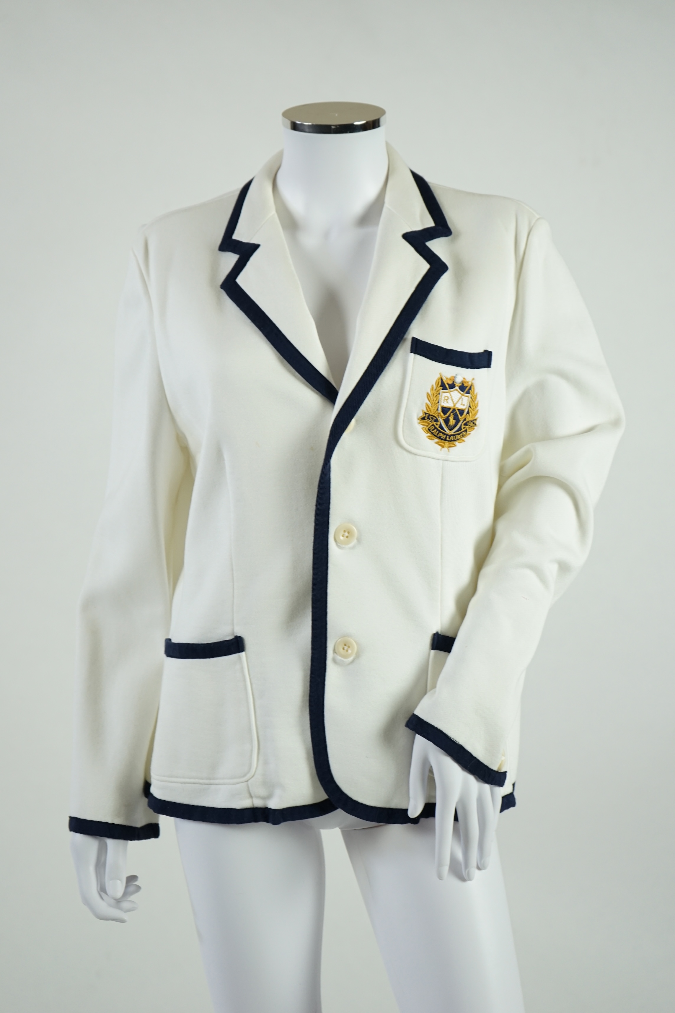 A cream Ralph Lauren blazer with navy blue cord piping. Proceeds to Happy Paws Puppy Rescue